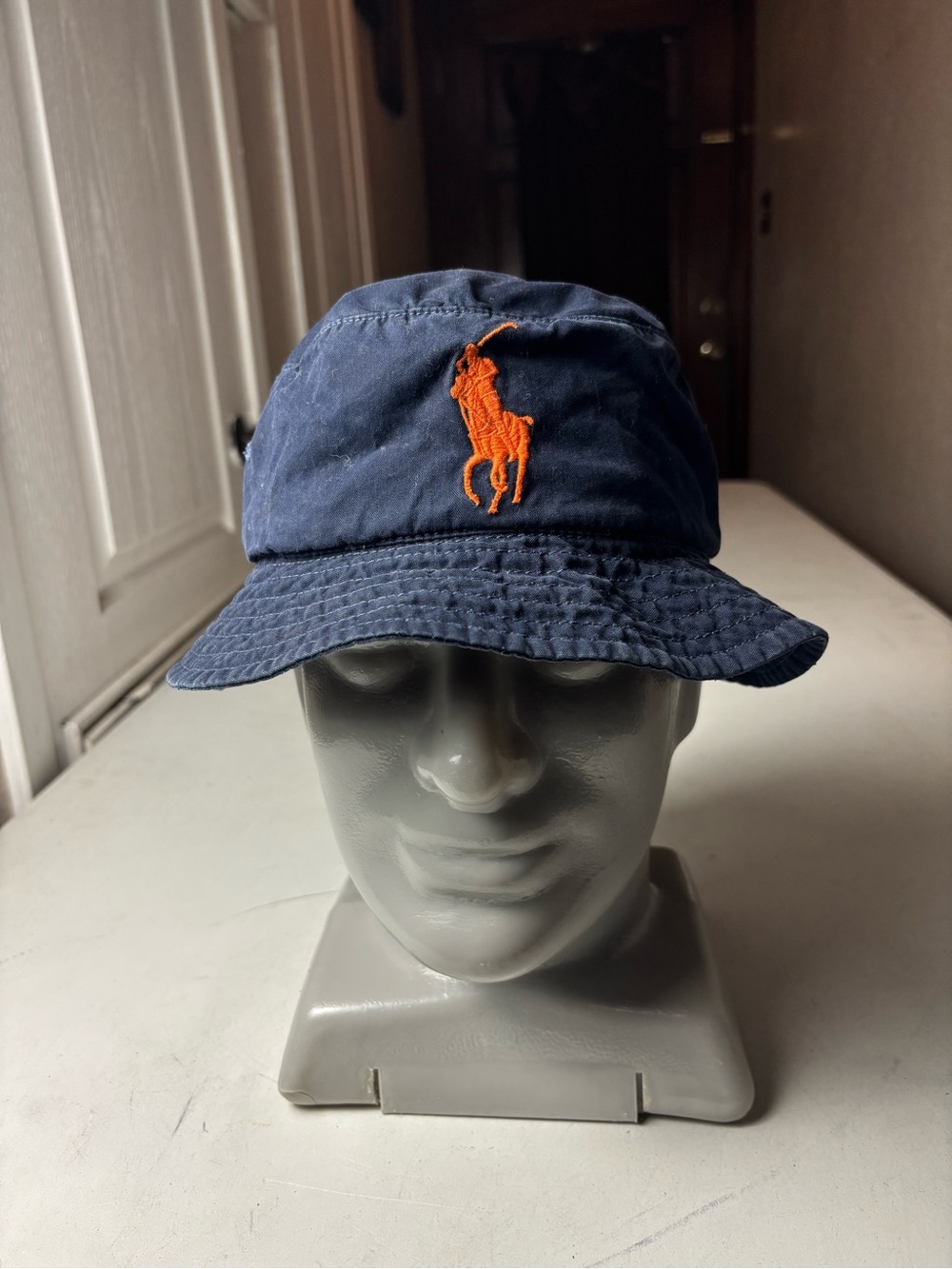 Vintage navy Polo Ralph Lauren bucket hat with orange embroidered pony logo
RARE